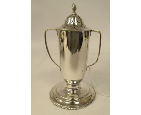 A silver caster of twin handled trophy vase form with a decoratively pierced cover and frame finial, on a bead bordered sauce