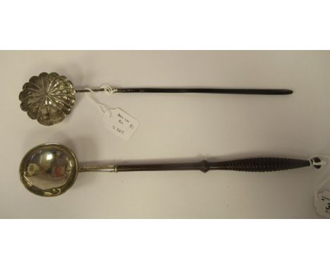 A 19thC silver coloured metal punch ladle with a circular bowl, on a carved and elliptically turned hardwood handle; and a co