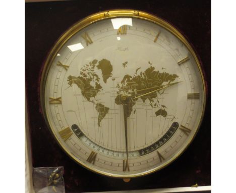 A 1960s Kienze lacquered brass cased World Clock, the mechanical movement faced by a silvered steel and brass Roman dial, inc