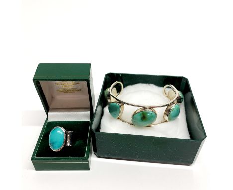 A heavy silver and turquoise ring together with a silver and turquoise bangle.