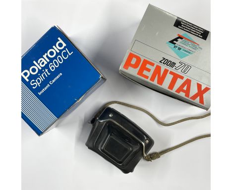 A boxed polaroid instant camera and Pentax zoom 70.