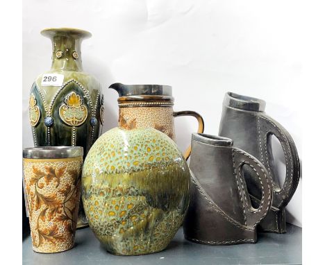 Three Royal Doulton stoneware items, largest H. 33cm, large vase repaired, together with a ceramic vase and two leather jugs.