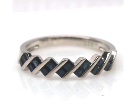 A 925 silver ring set with step cut sapphires, ring size N.5.