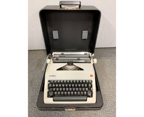 A cased vintage Olympia typewriter.