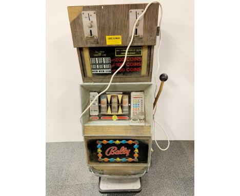 A vintage one arm bandit fruit machine, H. 114cm.