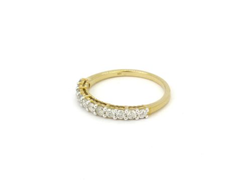 A 9ct yellow gold diamond set half eternity ring, (N.5).