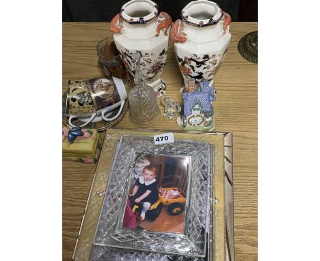 A group of photograph frames and ceramic items.