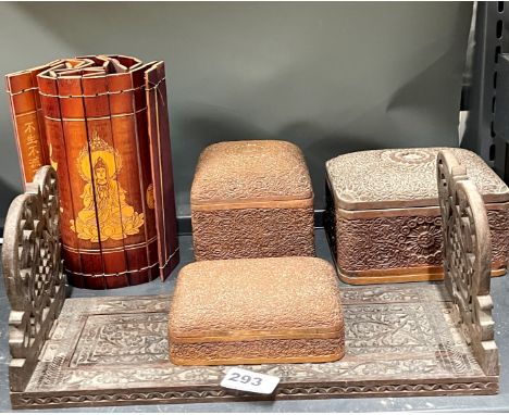 A Burmese carved hardwood sliding book rack with three Burmese boxes and a Chinese bamboo item.