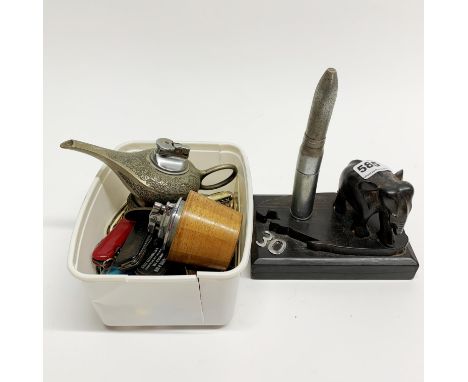 A hardwood elephant desk lighter with further lighters and pen knives.