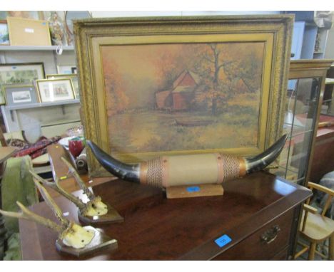 A mounted pair of cow horns, two deer antlers mounted on wall hanging wooden plaques and a gilt framed Robert West river land