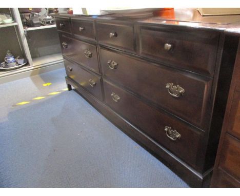 A Stagg mahogany low chest of four short drawers over two sets of longer drawers on bracket feet 28 x 61 2/8 x 18 2/8" along 