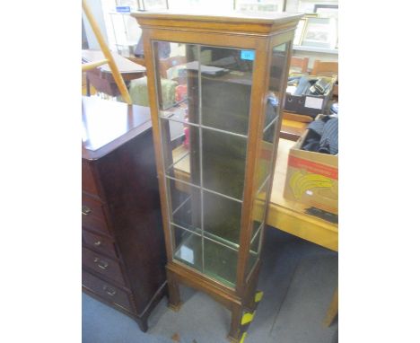 An early 20th century oak glazed cabinet having single door and square shaped feet, 60" h x 18 1/4"w 