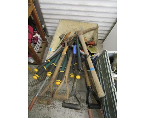 Mixed tools and wheelbarrow to include a pick, wooden handled forks, a rake and two metal ladders 