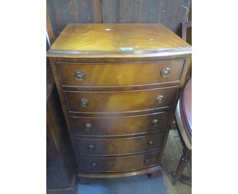 A reproduction flamed mahogany tallboy with five graduated drawers on ogee bracket feet, 36 1/2"h x 21"w 