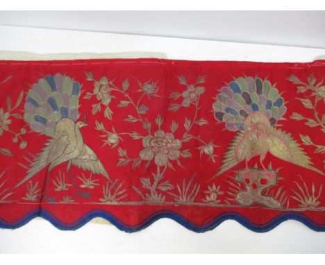 A 19th/20th century Chinese silk embroidered panel decorated with three peacocks, insects and flowers on a red ground, 13 3/4