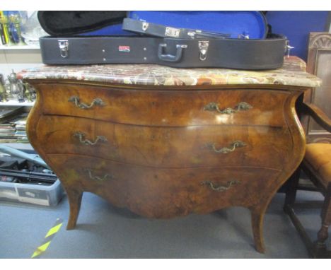 A late 20th century reproduction of a Louis IV walnut bombe commode with a mottled marble top over three long drawers with ca