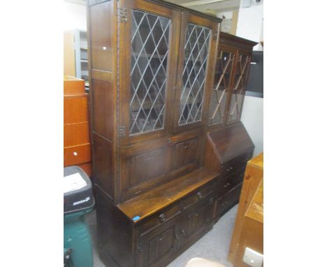 A mid 20th century oak linenfold display cabinet, together with an early 20th century walnut cabinet 