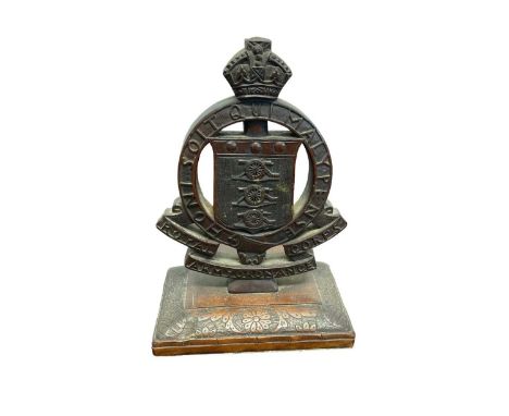 1920s/30s carved hardwood Royal Army Ordnance Corps Officers desk ornament with carved double sided regimental badge on flora