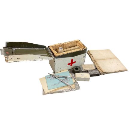 Military ammunition box painted as a first aid tin and filled with contents, together with various maps and booklets.