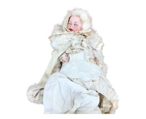 A charming group of three antique dolls together with a facsimile photograph of the original owner (born in 1913) as a child 