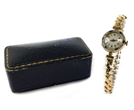 LADY'S ART DECO BLUE GEM AND DIAMOND SET MANUAL WIND WRIST WATCH, the round white dial with Arabic hour markers in black, the