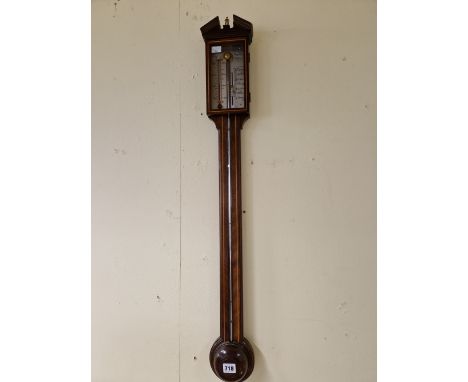 A COMITTI LINE INLAID MAHOGANY STICK BAROMETER WITH AN ALCOHOL THERMOMETER TO ONE SIDE OF THE SILVERED SCALE.   H 97cms.