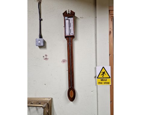 A CONTEMPORARY MAHOGANY STICK BAROMETER BY PETER WIGGINS, A BROKEN PEDIMENT ABOVE THE SILVERED DIAL, THE COLUMN FLANKED BY BA