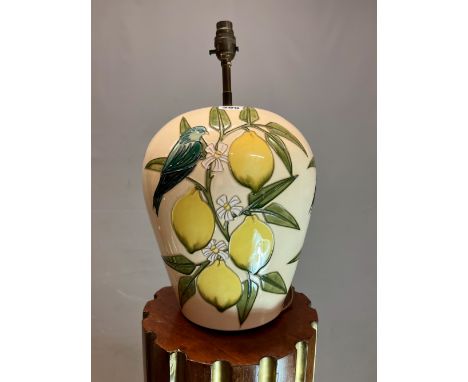 A MOORCROFT OVOID TABLE LAMP SLIP TRAILED WITH BLUE BIRDS ON LEMON BRANCHES AGAINST A CREAM GROUND.   H 44cms.