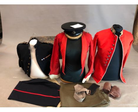 A TIN TRUNK CONTAINING A COLDSTREAM GUARD CAPTAINS CAP, JACKET AND TROUSERS, A PAIR OF KHAKI BRITCHES, A BLUE JACKET AND A KI