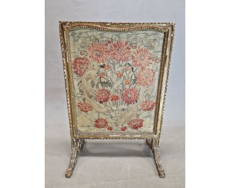 A GILT WOOD FIRESCREEN WITH THE NEEDLE WORK PANEL WORKED WITH RED CARNATIONS.   92 x 64cms.