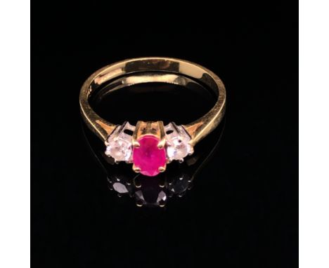 A RUBY AND DIAMOND THREE STONE TRILOGY RING. THE CENTRAL CUSHION CUT RUBY IN A CLAW SETTING, MEASUREMENTS 5.5 X D 3.4mm. , TH