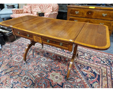 A REGENCY SATIN WOOD CROSS BANDED RED WOOD SOFA TABLE, THE ROUNDED RECTANGULAR FLAP TO WITH A STREAKY GRAIN ABOVE TWO DRAWERS