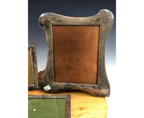 THREE 20th C. SILVER PHOTOGRAPH FRAMES, THE SMALLEST CRESTED BY A NAVAL INSIGNIA, THE LARGEST.   30 x 24.5cms.