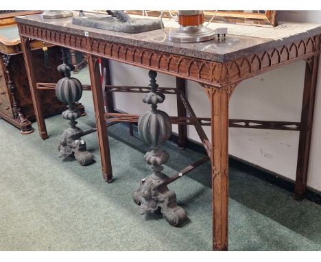 A GRANITE TOPPED ROSEWOOD CONSOLE TABLE, THE APRON CARVED WITH AN OGEE ARCH BAND ABOVE SIX SQUARE SECTIONED LEGS JOINED BY TW