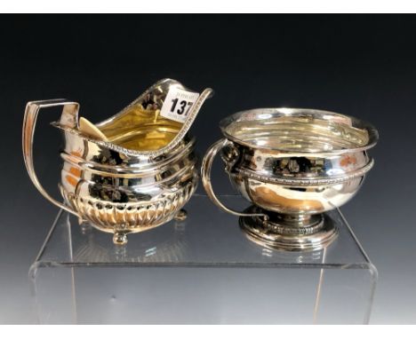 A GEORGE III SILVER CREAM BOAT, THE LONDON MARKS WORN AND A SILVER CUP BY THE GOLDSMITHS AND SILVERSMITHS COMPANY, LONDON 190