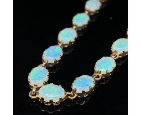 A HALLMAKKED 9ct GOLD SIXTEEN STONE OVAL CABOCHON CUT OPAL BRACELET. EACH OPAL IN A VICTORIAN STYLE EIGHT CLAW SETTING. LENGT