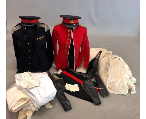A TIN TRUNK CONTAINING A COLONELS DRESS JACKET TROUSERS AND BOOTS, SIX PAIRS OF WHITE RIDING BRITCHES, AN OXFORD LIGHT INFANT