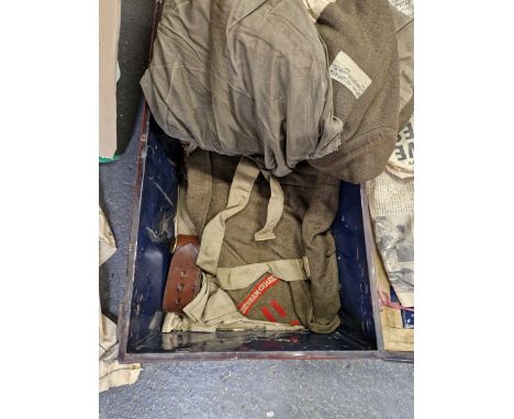 A TIN TRUNK CONTAINING KHAKI UNIFORMS FOR A CAPTAIN OF THE COLDSTREAM GUARDS