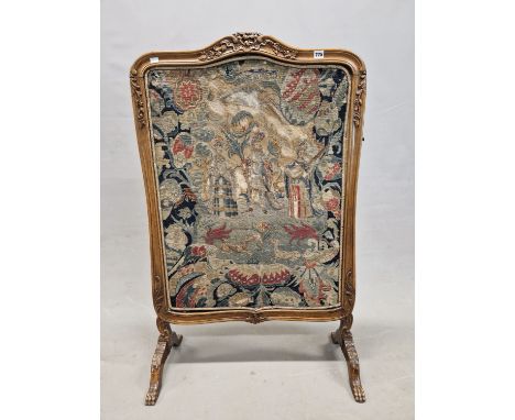 AN EARLY 20th C. MAHOGANY FIRE SCREEN, THE CENTRE OF THE SERPENTINE TOP CARVED WITH FLOWERS, THE 18th C. WOOLWORK INSET DEPIC