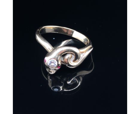 A 20th CENTURY STYLISED COILED SERPENT RING SET WITH A DIAMOND SET HEAD AND RUBY EYE. FINGER SIZE R. WEIGHT 5.12 grams