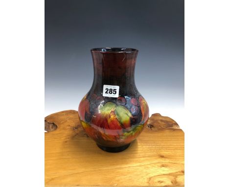 A WILLIAM MOORCROFT GRAPE PATTERN VASE, THE VINE LEAVES IN AUTUMNAL COLOURS.   H 22.5cms. 