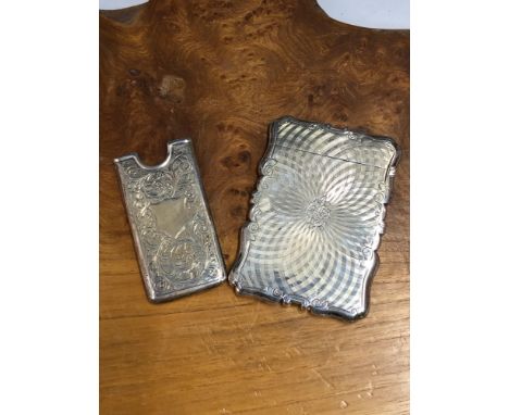 A SILVER CARD CASE BY NATHANIEL MILLS, BIRMINGHAM 1844, ENGINE TURNED ABOUT A CREST ON ONE SIDE AND FLOWERS ON THE OTHER, 72G