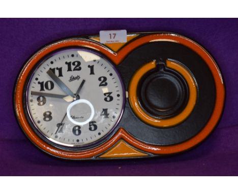 A German 1970s Schatz Elexacta ceramic wall clock,having brown and orange ground.