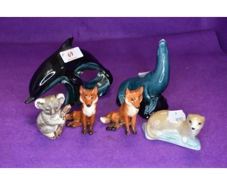 Three Beswick studies, Fox, seated, small 1748 x2, Koala Bear on Branch 1039, two poole studies of a Dolphin and Sea Lion alo