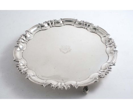 AN EDWARDIAN SALVER of shaped circular outline with a moulded scroll border, the centre engraved with a crest & motto, by Mes