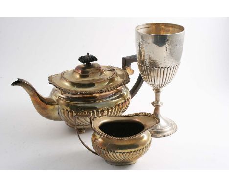 AN EDWARDIAN PART-FLUTED TEA POT on bun feet with a gadroon & shell border, by G. Nathan & R. Hayes, Chester 1905, a part-flu