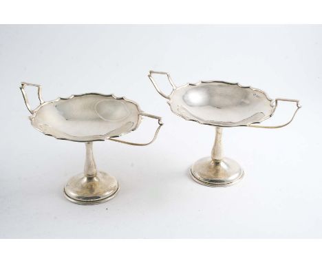 A PAIR OF EDWARDIAN PEDESTAL BONBON DISHES with twin handles & shaped & moulded rims, by Messrs. Hutton & Sons Ltd., Birmingh