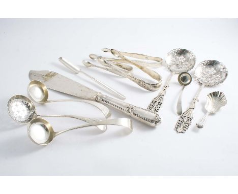 A MIXED LOT:- A pair of engraved sugar tongs by Hester Bateman, two other pairs of sugar tongs, a George III marrow scoop, a 