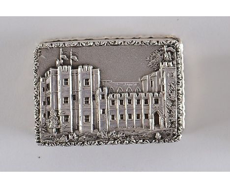 AN EARLY VICTORIAN "CASTLE TOP" VINAIGRETTE oblong with reeded sides, an engine-turned base & raised borders, the cover with 