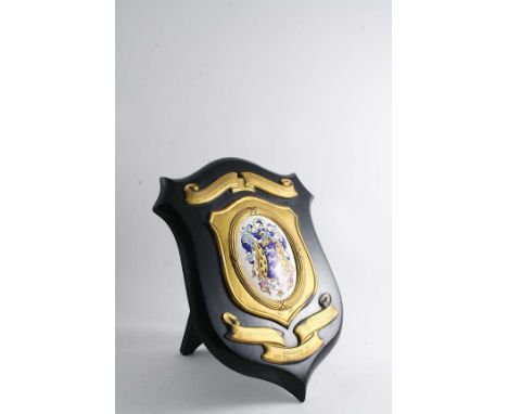 A SILVERGILT MOUNTED WOODEN CHALLENGE SHIELD with an enamelled coat of arms in the centre, inscribed "Harper Adams Agricultur